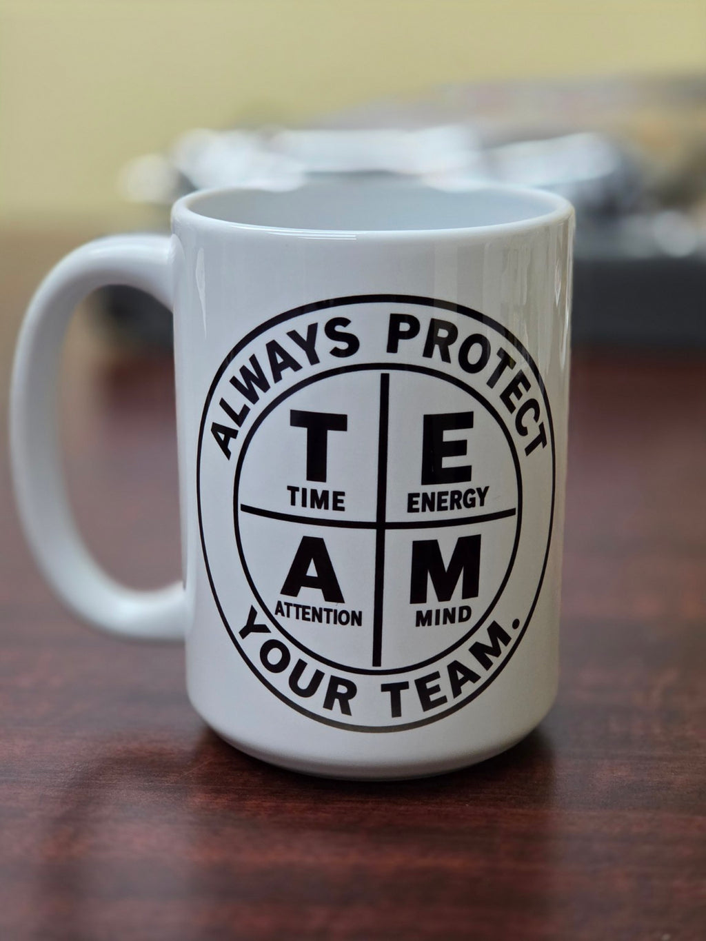 Close up of Always Protect Your T.E.A.M. 15 oz white ceramic mug